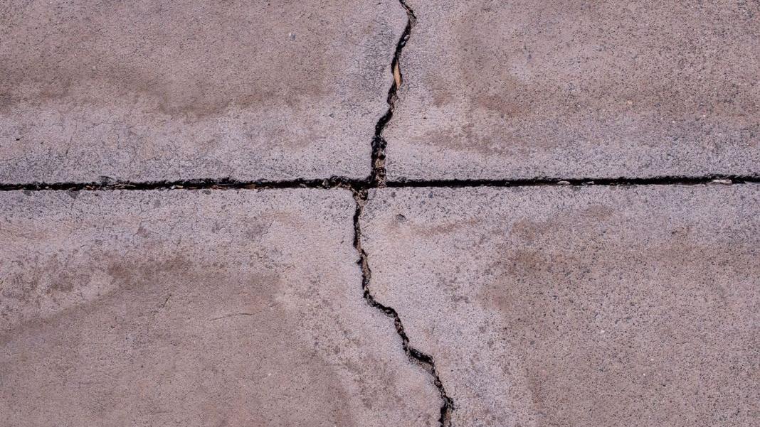 Cracks running across a poured concrete slab