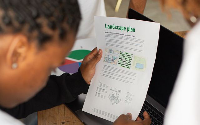 A person reviewing a landscape plan