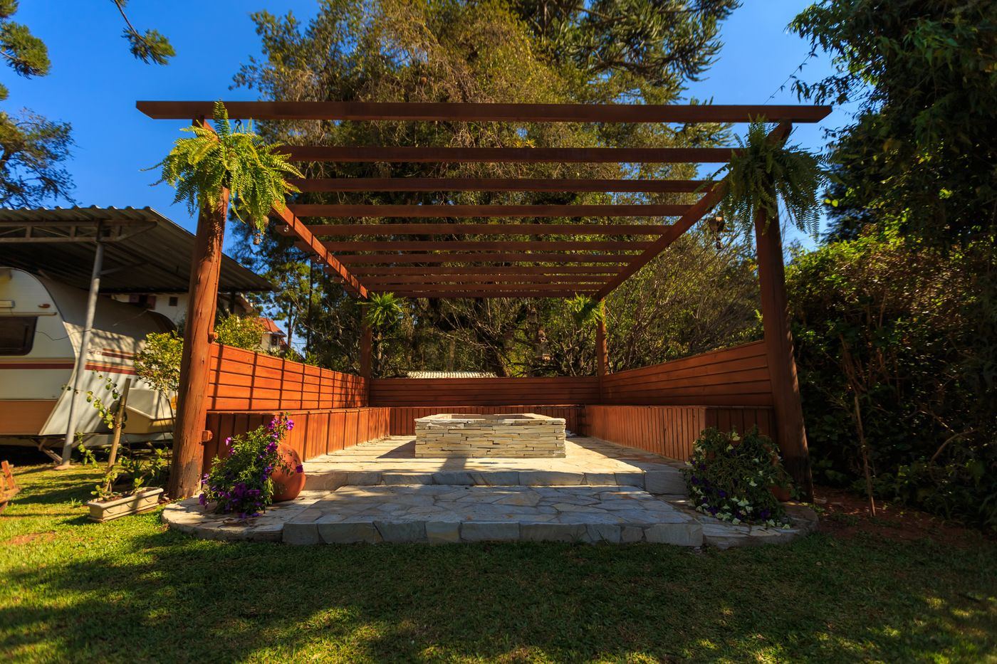 Wooden pergola over a seating area in a garden